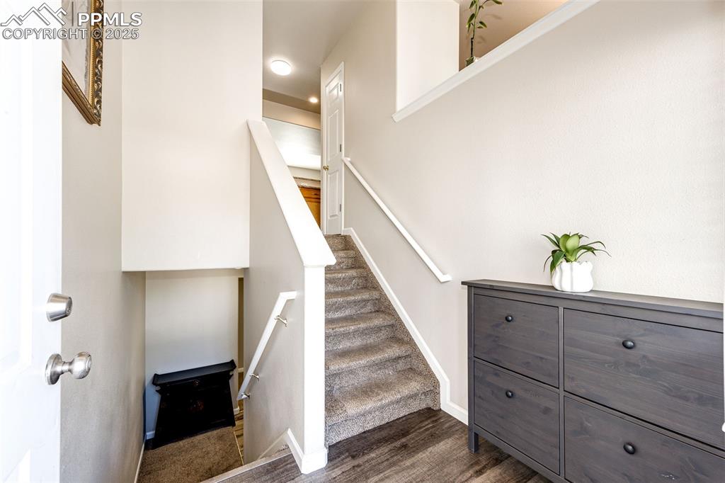 Image 4 of 34: Staircase featuring wood finished floors and baseboards