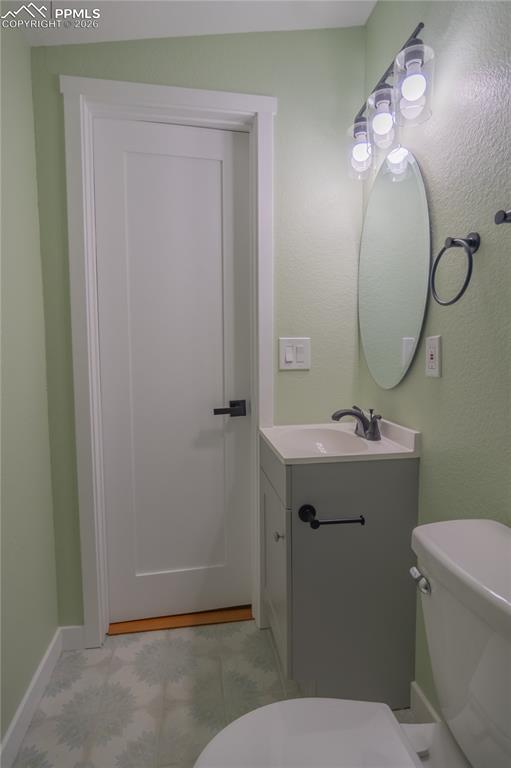 Image 13 of 18: Bathroom with toilet and vanity
