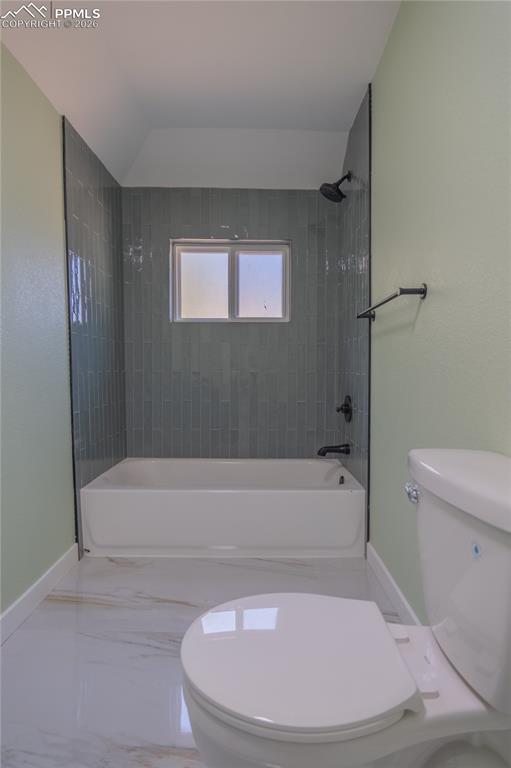 Image 14 of 18: Main Bathroom with bathing tub / shower combination and marble tiled floors