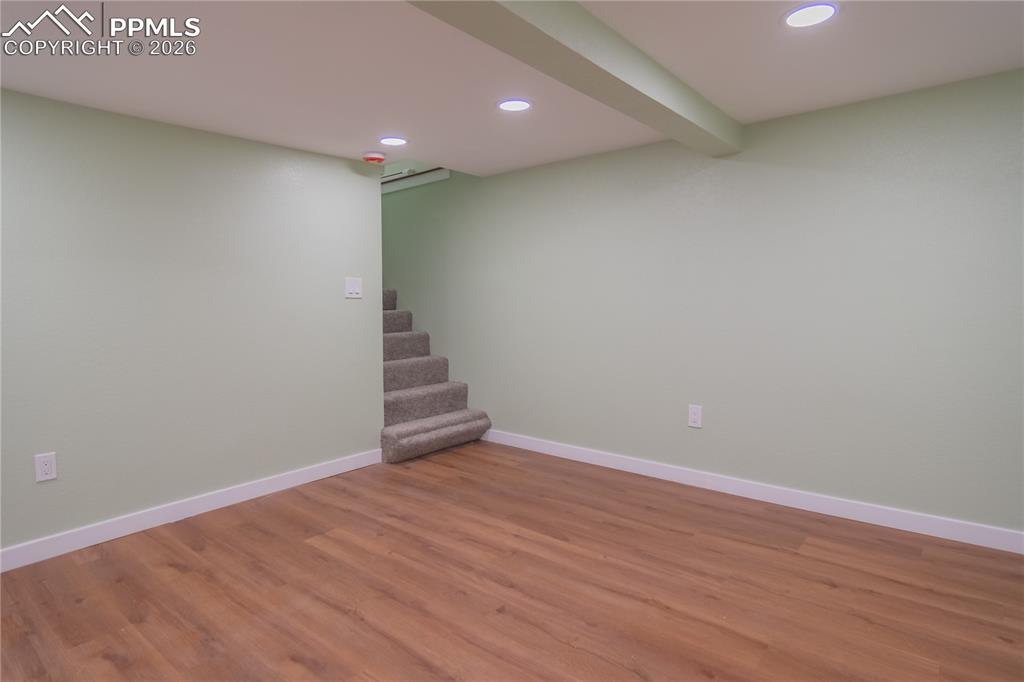 Image 17 of 18: Finished below grade area featuring recessed lighting, wood finished floors