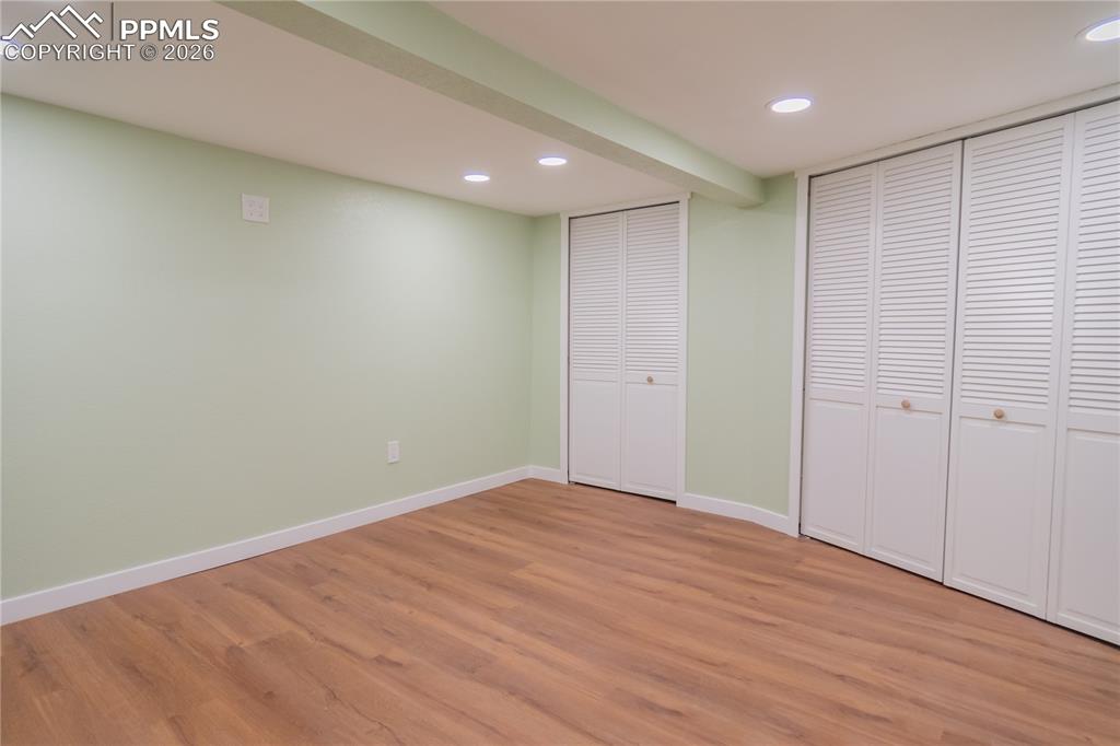 Image 18 of 18: finished basement featuring enclosed laundry area, light wood-type flooring