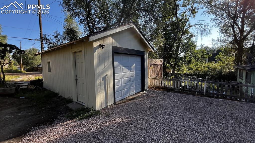 Image 4 of 18: Detached garage featuring driveway
