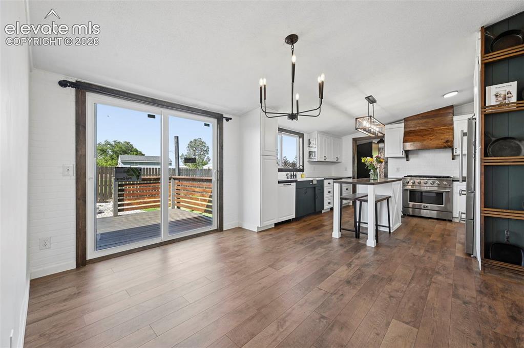 Image 10 of 44: Walk Out Dining Room to Large Wood Deck-Brand new Sliding door 