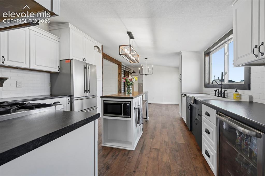 Image 15 of 44: Solid Surface Counters and Brand New LVP flooring