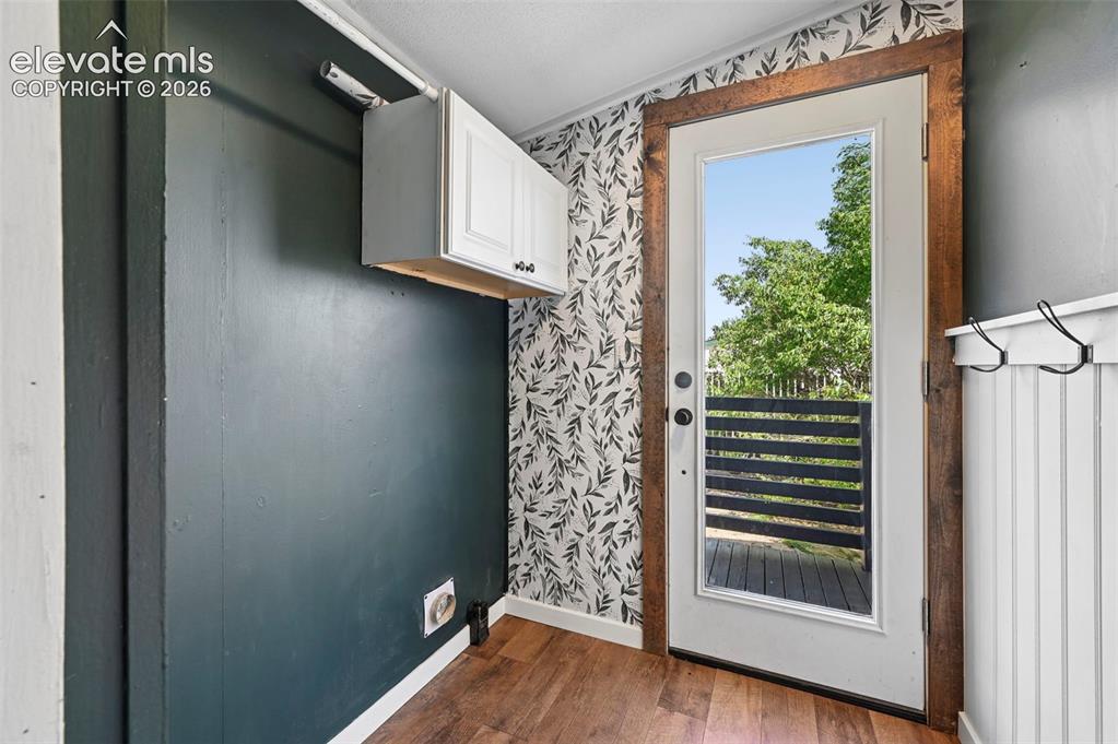 Image 17 of 44: Washer/Dryer Area- Walks out to side of home, perfect section for a dog run