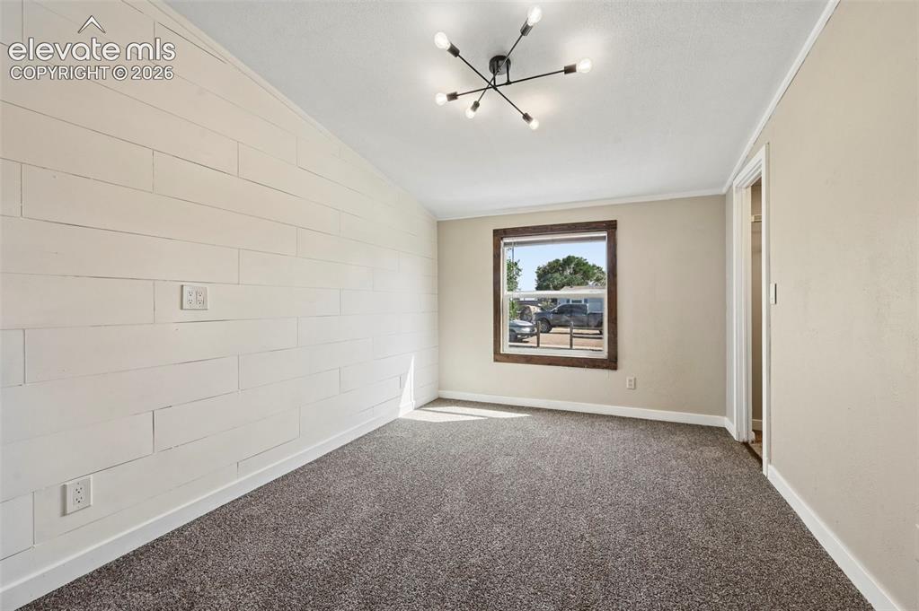 Image 24 of 44: Bedroom #1 Brand New Carpet, Shiplap Walls, Walk in Closet and Barn Door