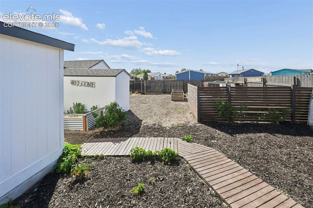 Image 35 of 44: Side Yard-Sectioned off for RV/5th Wheel Parking thru Dbl Gates and to the 