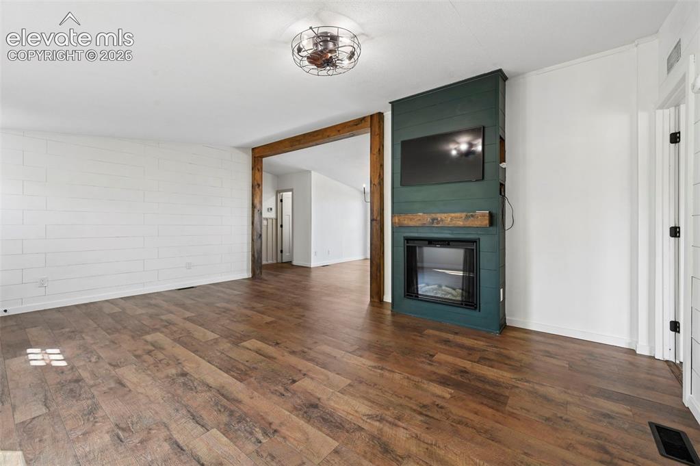 Image 8 of 44: Lots of New Upgrades Throughout!  Accent Wall with TV and Electrical Firepl