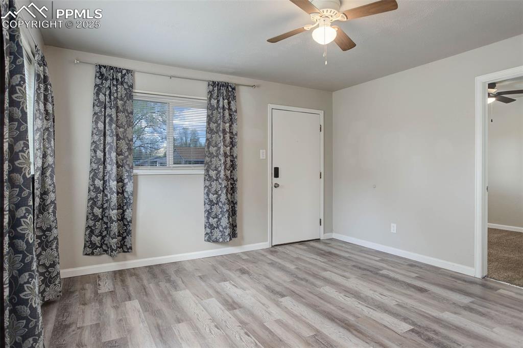 Image 5 of 23: Empty room featuring ceiling fan and light hardwood / wood-style flooring