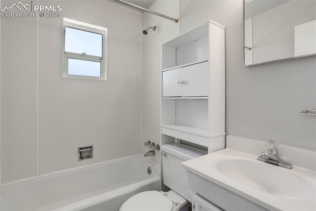 Image 7 of 23: Full bathroom featuring vanity, toilet, and shower combination