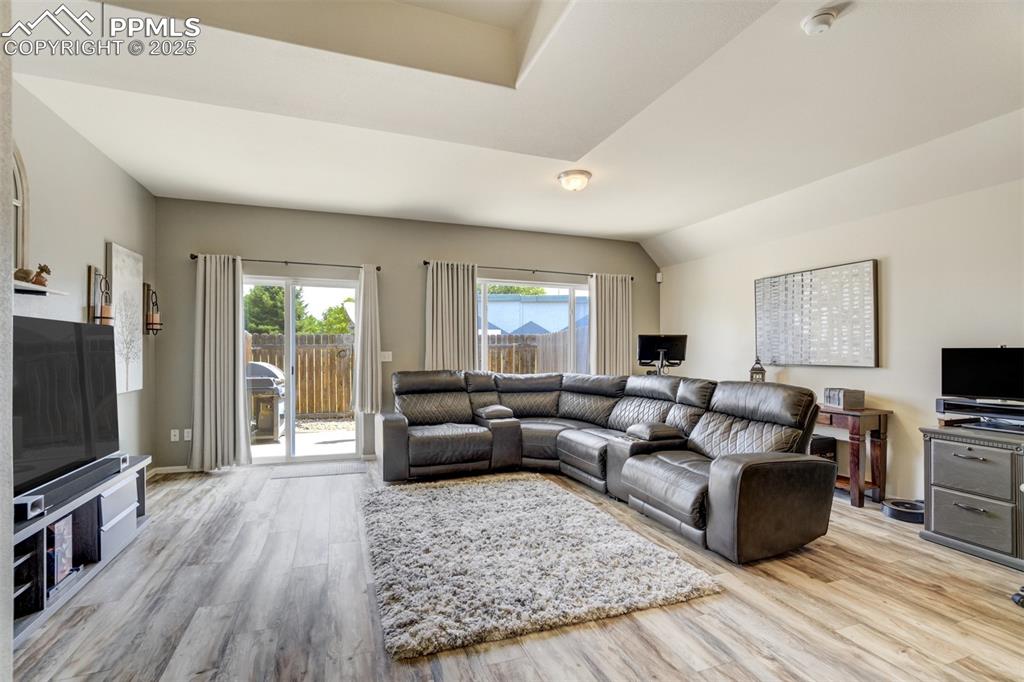 Image 3 of 41: new laminate wood flooring entire main level, slider to fenced patio yard