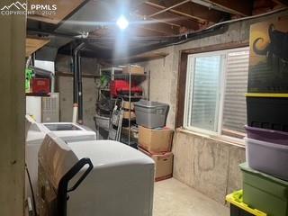 Image 12 of 30: Storage featuring washer and clothes dryer