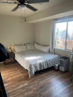 Image 22 of 30: Bedroom with wood finished floors and ceiling fan