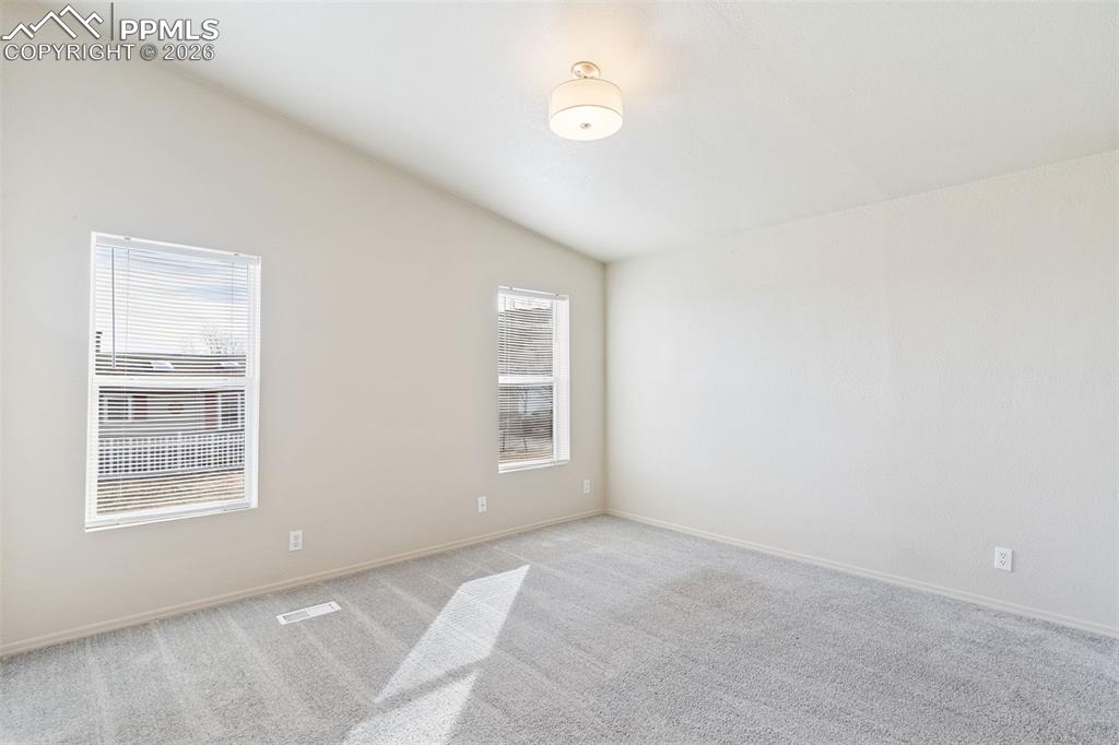 Image 10 of 18: The kitchen includes a spacious bar which can function as an informal dinin