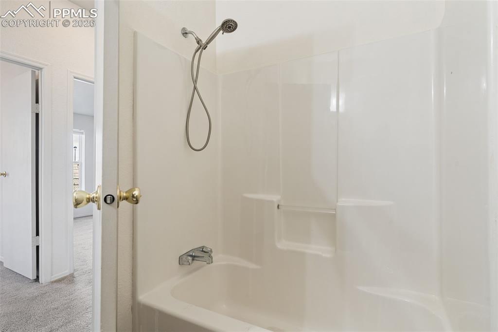 Image 21 of 28: The primary full bath is appointed with a large vanity.