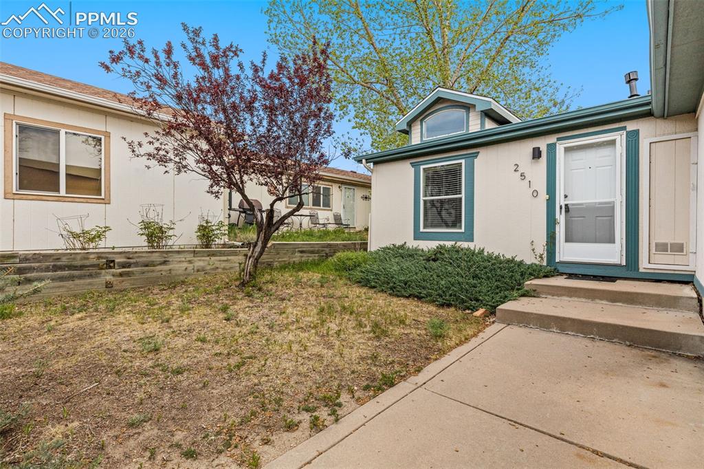 Image 26 of 28: A 2-car garage and concrete driveway provide plenty of room for your vehicl