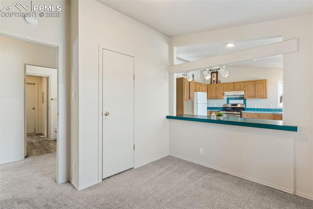 Image 8 of 18: The living room leads to the inviting roomy kitchen.