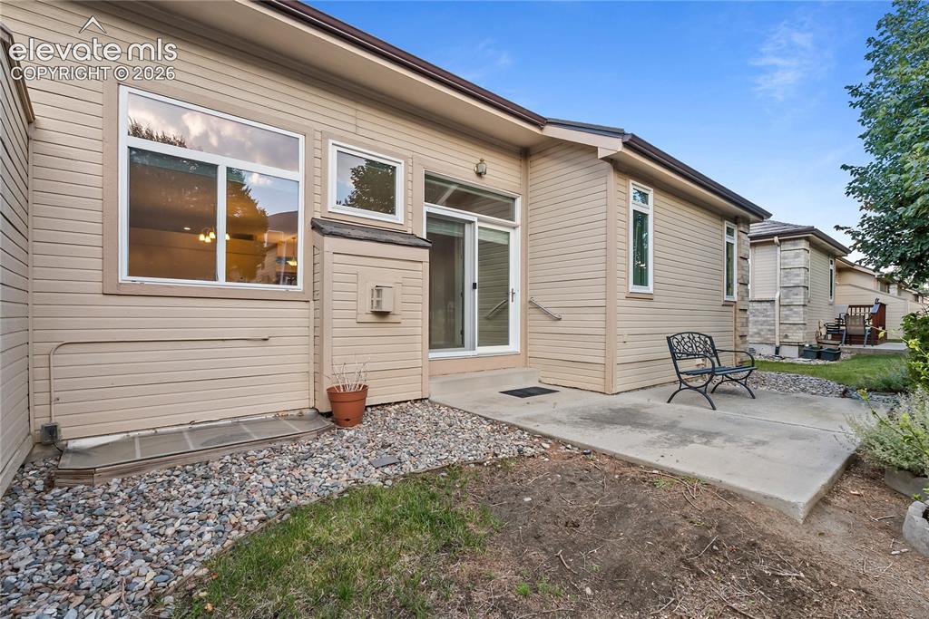 Image 18 of 41: Exterior patio area featuring a concrete slab, sliding glass door access, a