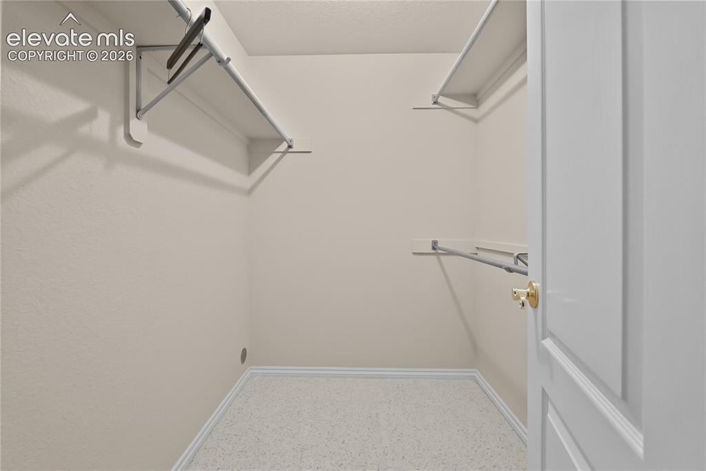 Image 28 of 41: Walk-in closet featuring light-colored walls, white trim, and light-toned c