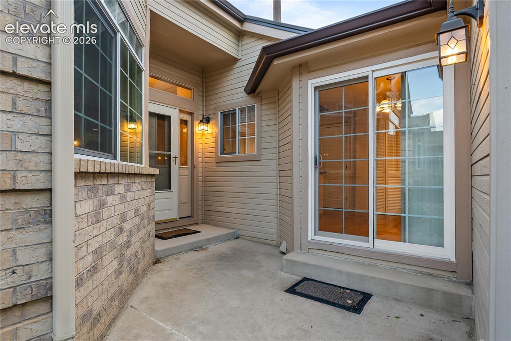 Image 4 of 41: Exterior entry featuring light-toned brick and horizontal siding