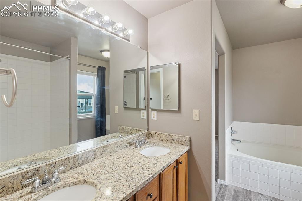 Image 15 of 32: Upper primary bedroom suite, attached bathroom, walk-in closet