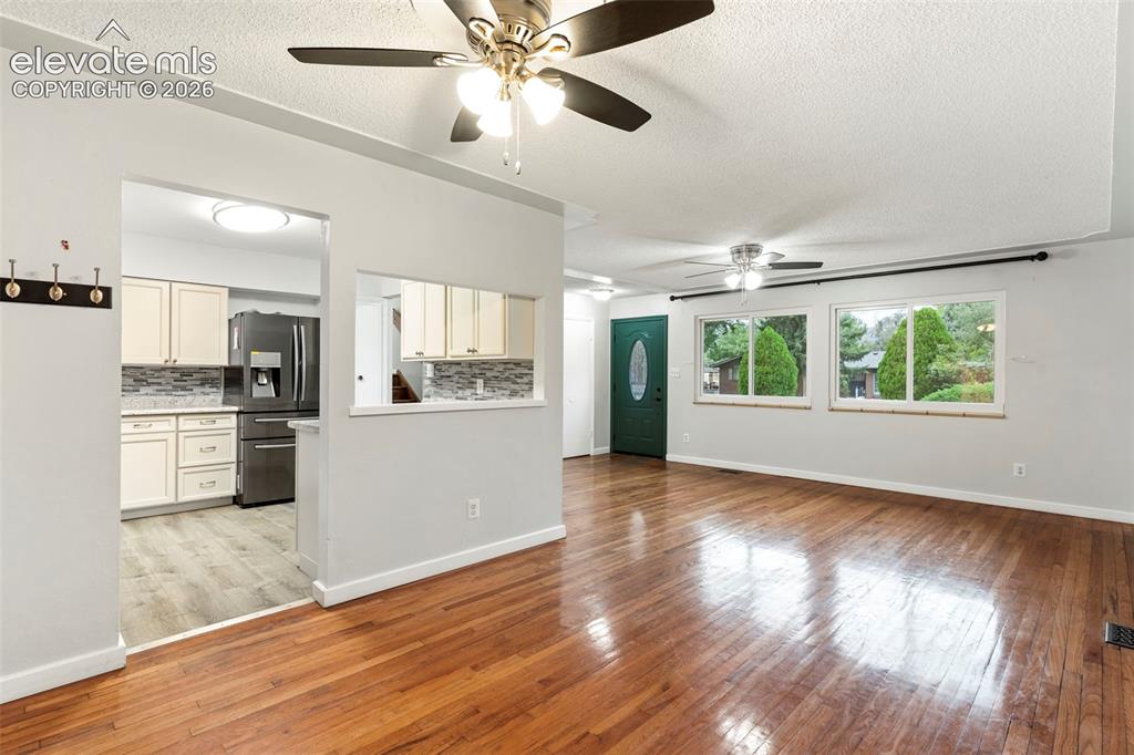 Image 13 of 36: Hardwood flooring throughout the main living area