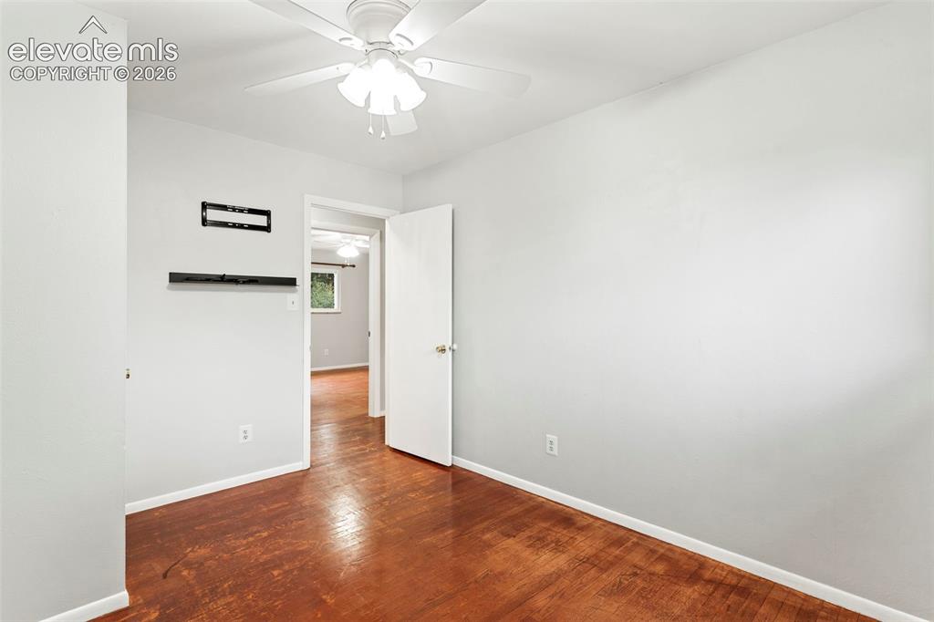 Image 29 of 36: White ceiling fan with integrated lighting
