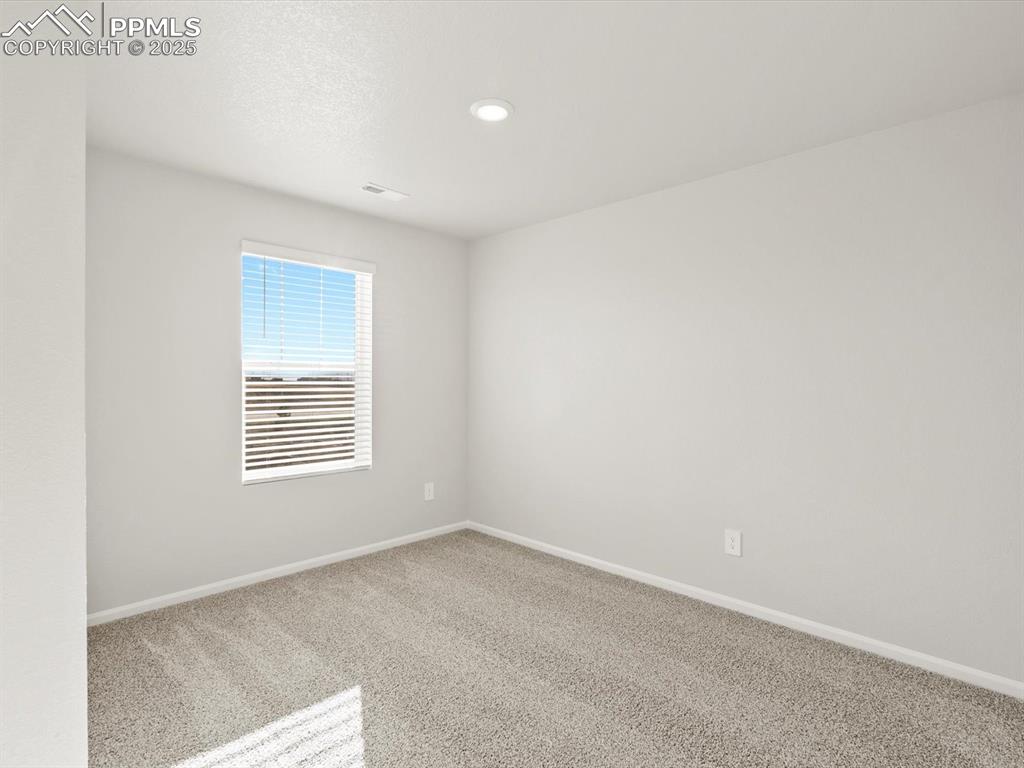 Image 15 of 26: Unfurnished room featuring carpet, recessed lighting, and a textured ceilin