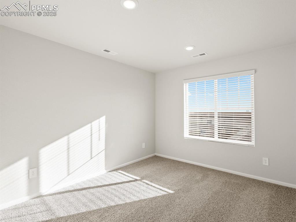 Image 17 of 26: Carpeted spare room featuring baseboards and recessed lighting