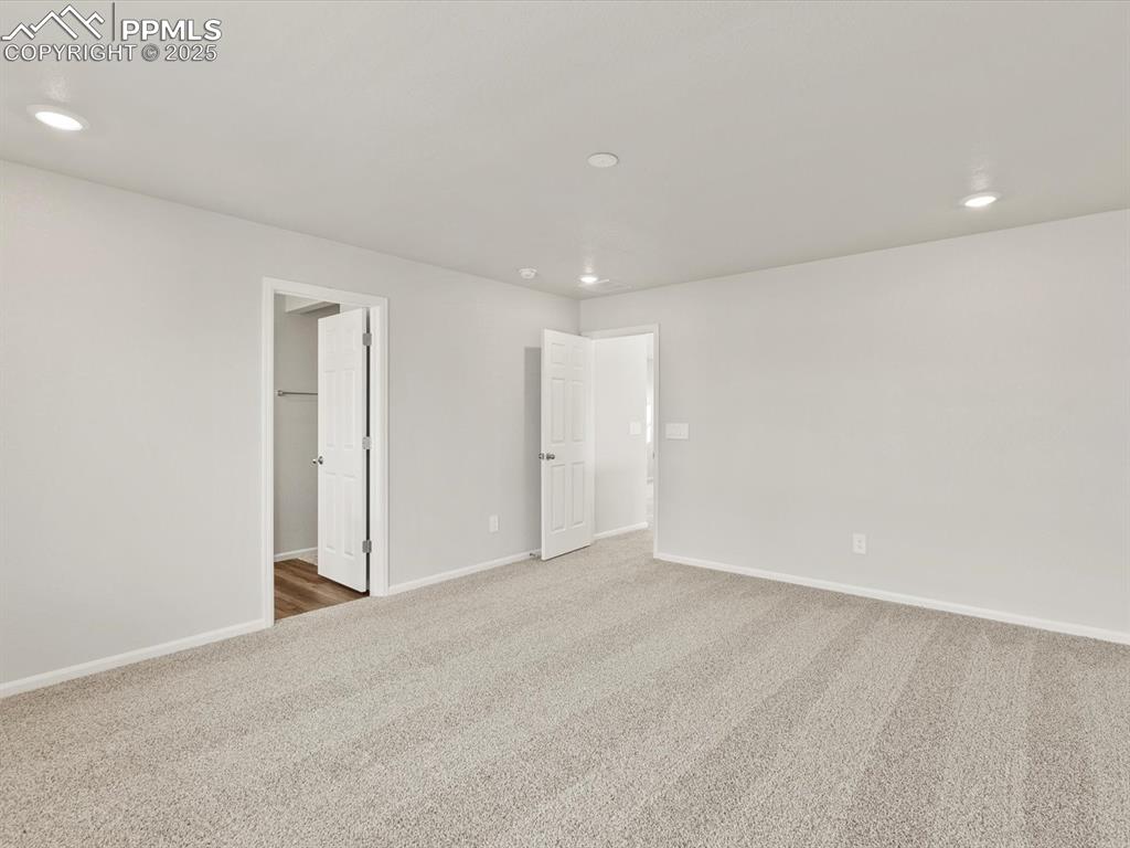 Image 21 of 26: Unfurnished bedroom with recessed lighting and carpet flooring