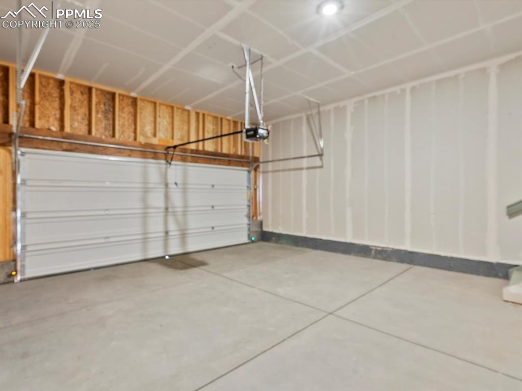 Image 25 of 26: Garage featuring a garage door opener