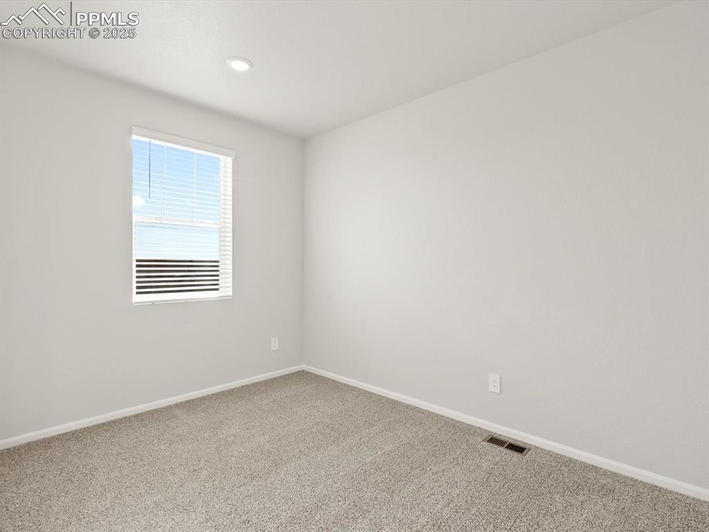 Image 9 of 26: Empty room with carpet floors and recessed lighting