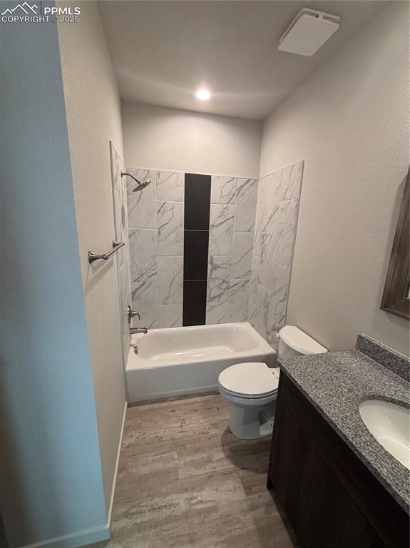 Image 10 of 13: Full bathroom with light wood-type flooring, vanity, shower / bathtub combi