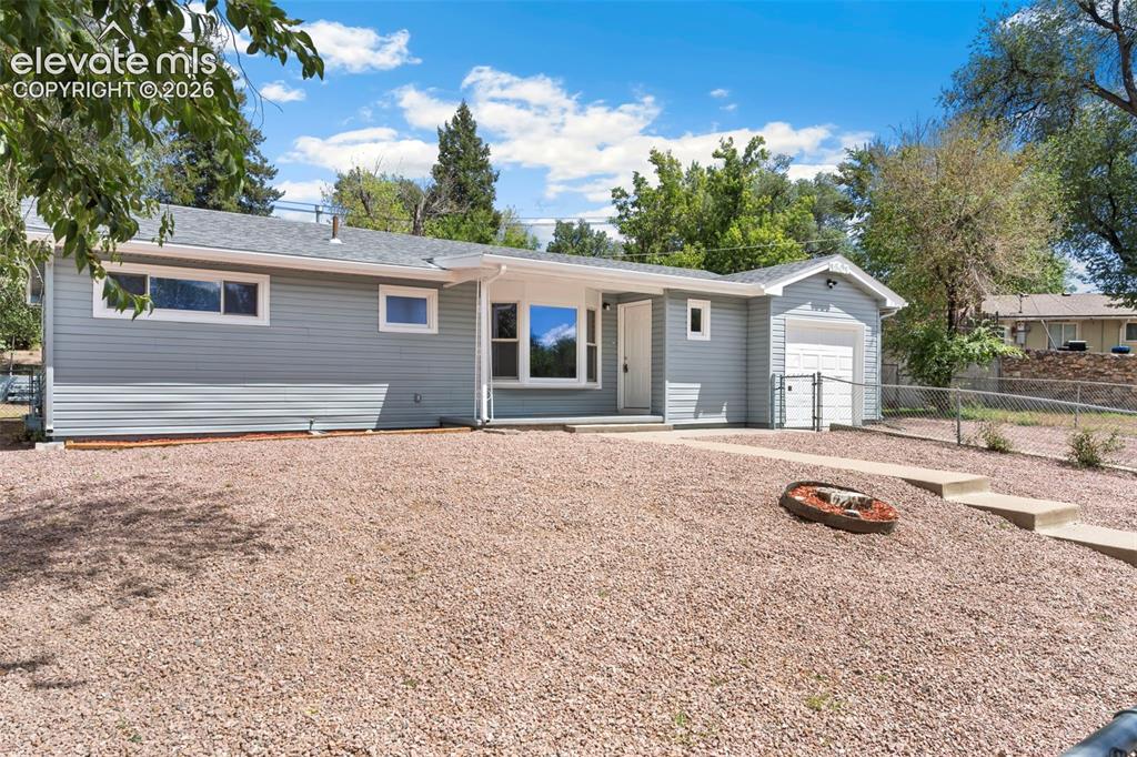 Image 11 of 33: Single-story exterior with light blue horizontal siding