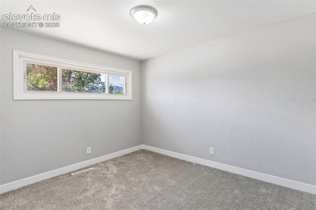 Image 21 of 33: Recessed flush-mount ceiling light, light gray wall finish, white baseboard