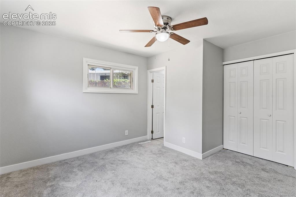 Image 25 of 33: Light gray wall paint, gray carpeting, and white trim