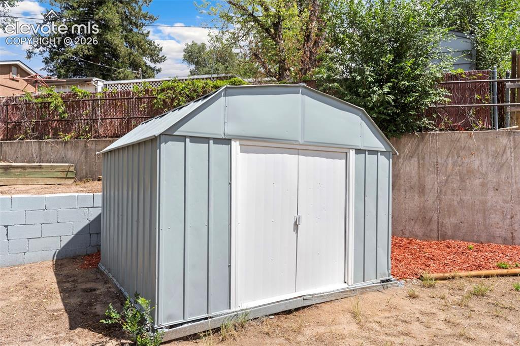 Image 33 of 33: Freestanding metal storage shed with double entry doors