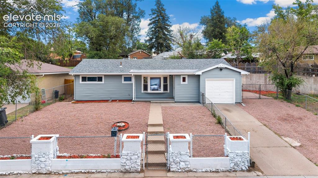 Image 5 of 33: Single-story exterior with light blue siding, an attached single-car garage