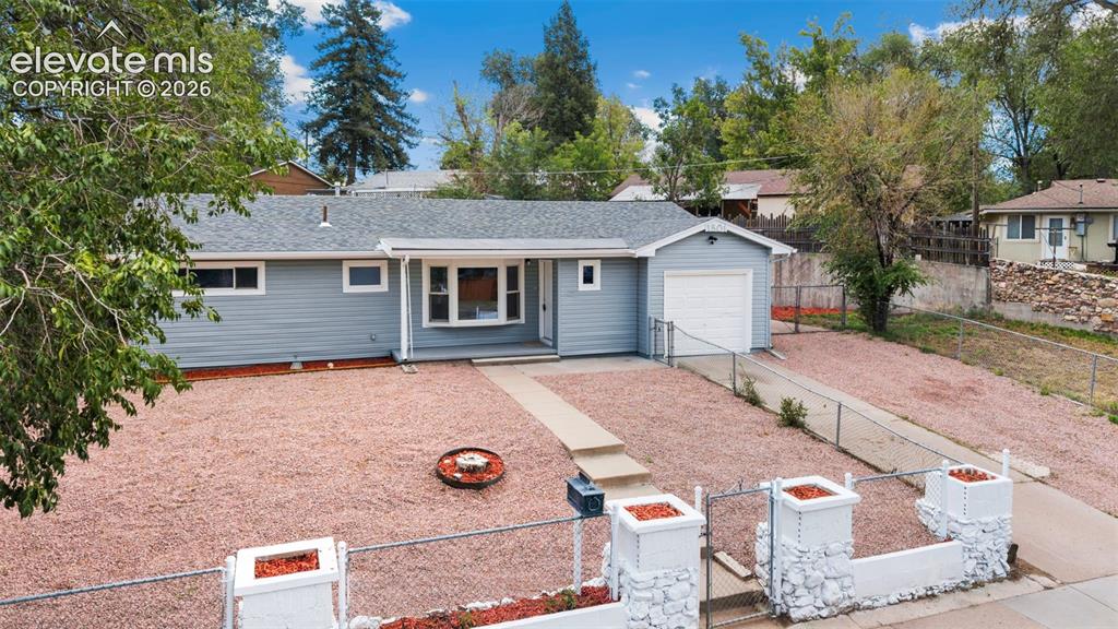 Image 6 of 33: Exterior featuring light blue siding, a single-car garage, a concrete drive
