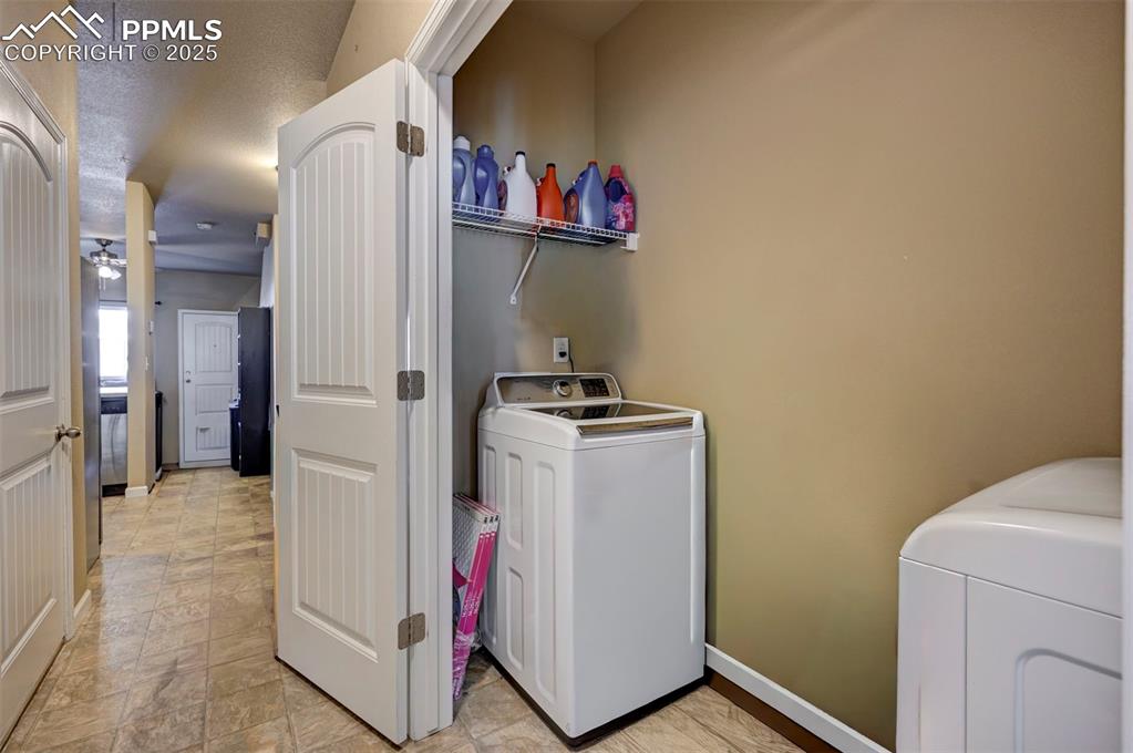 Image 10 of 29: Laundry area with washer and dryer and a textured ceiling