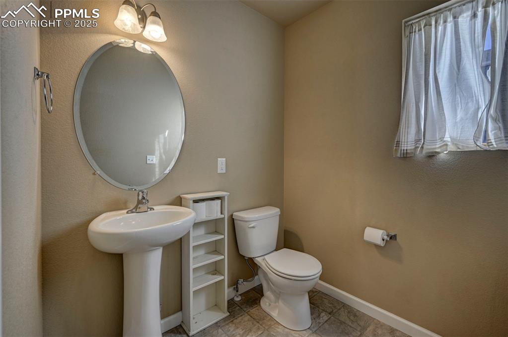 Image 11 of 29: Half bathroom with toilet and baseboards