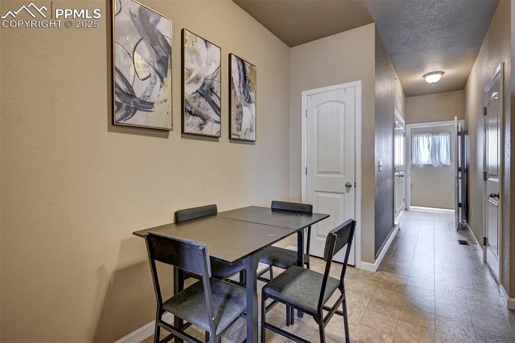 Image 9 of 29: Dining room featuring a textured wall and a textured ceiling