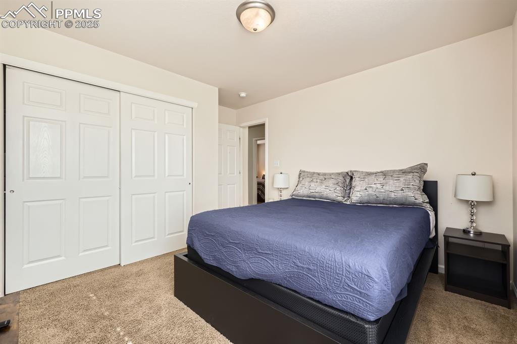 Image 20 of 39: Bedroom with carpet and a closet