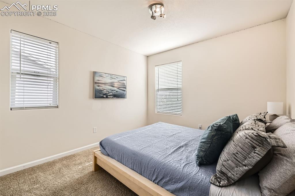 Image 22 of 39: Carpeted bedroom featuring baseboards