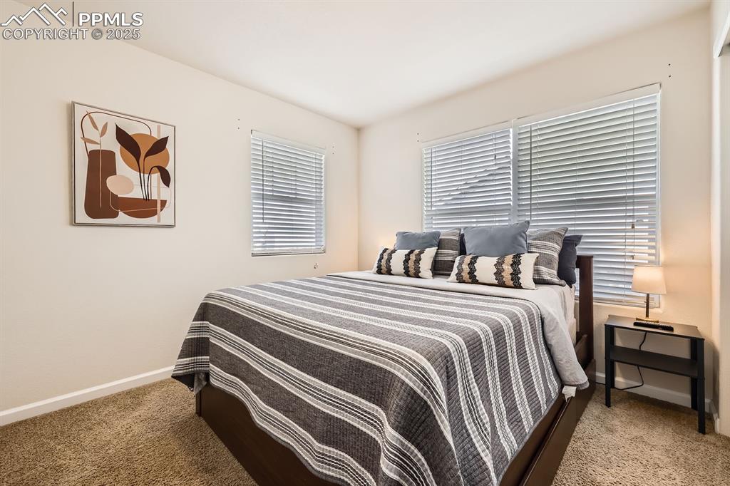 Image 24 of 39: Carpeted bedroom with baseboards