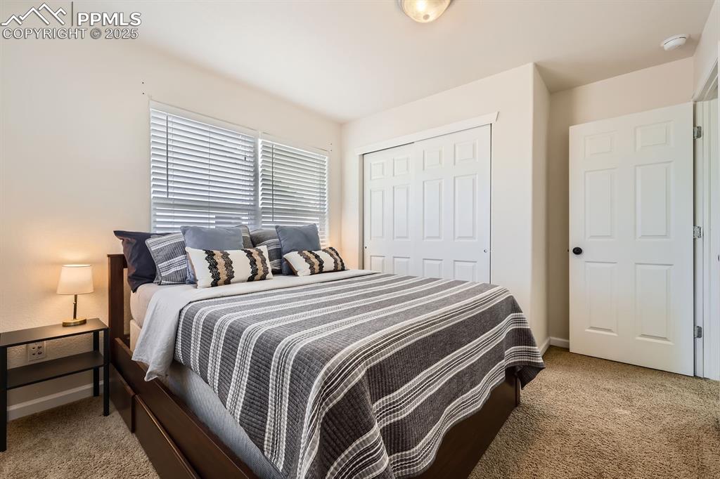 Image 25 of 39: Bedroom with light colored carpet and a closet