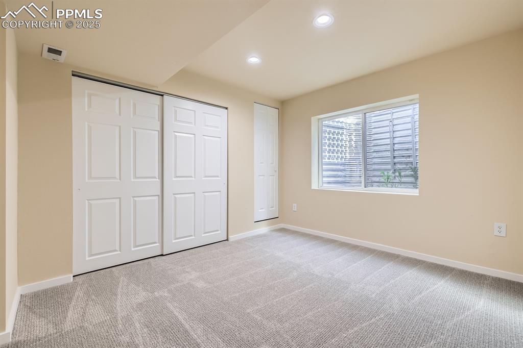 Image 32 of 39: Unfurnished bedroom featuring light colored carpet, recessed lighting, and 