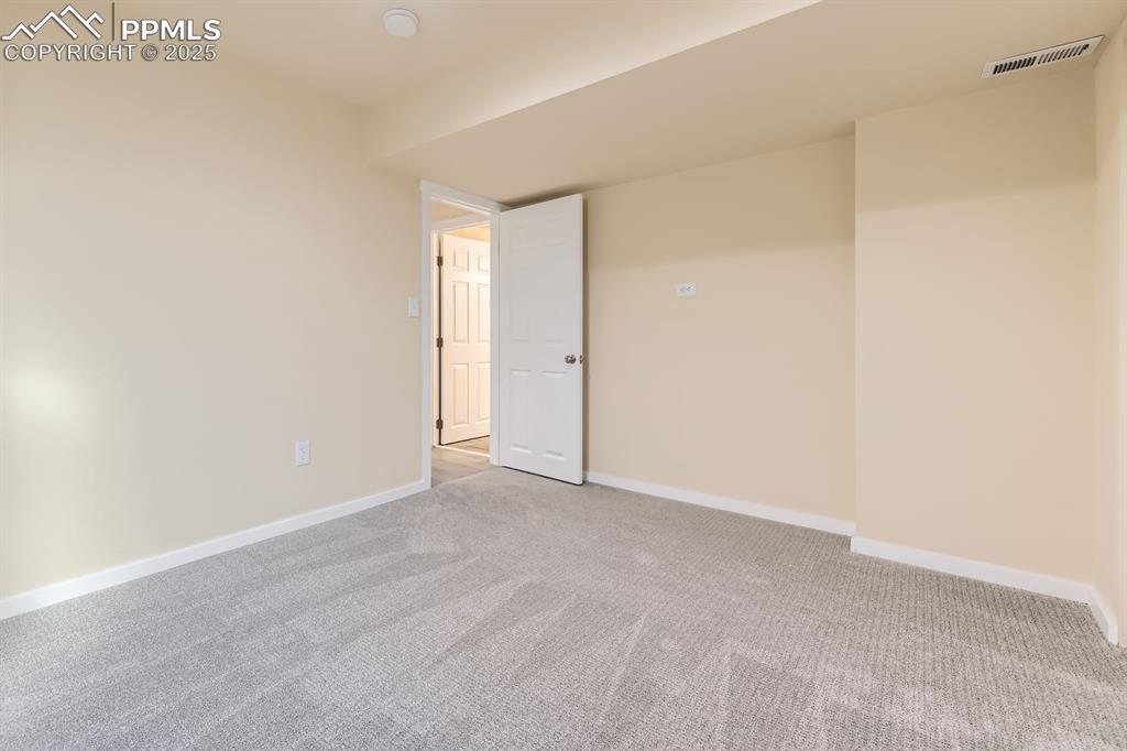 Image 33 of 39: Carpeted empty room with baseboards