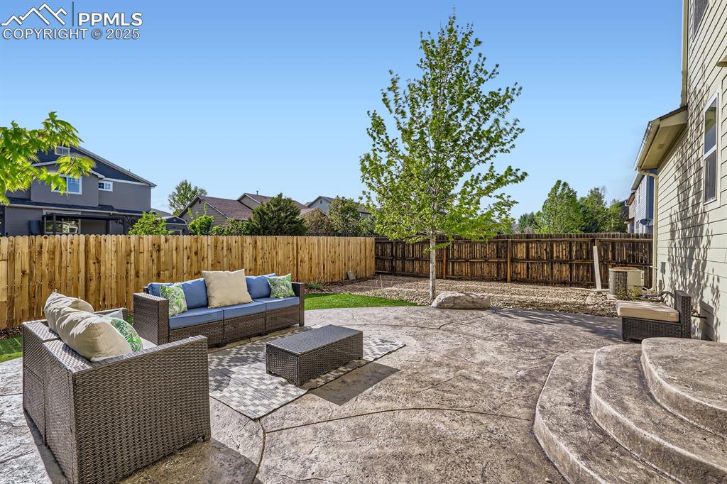 Image 37 of 39: Fenced backyard featuring a patio and an outdoor living space