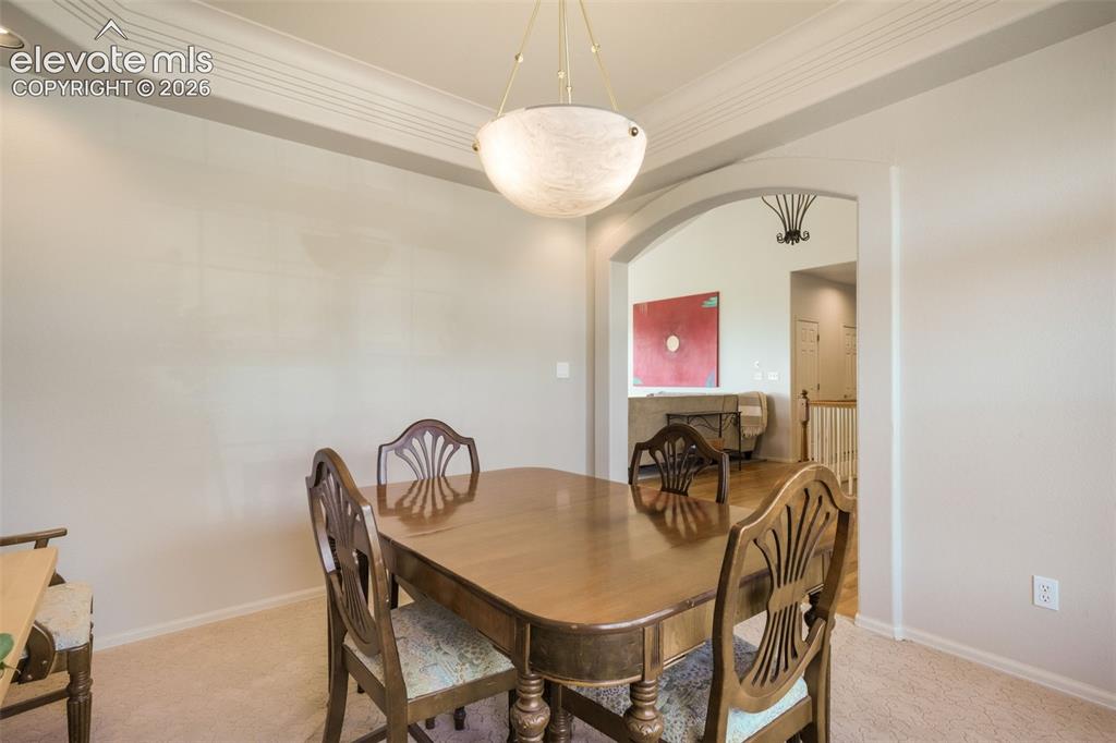 Image 17 of 50: Kitchen featuring white cabinetry, stainless steel appliances, a center isl